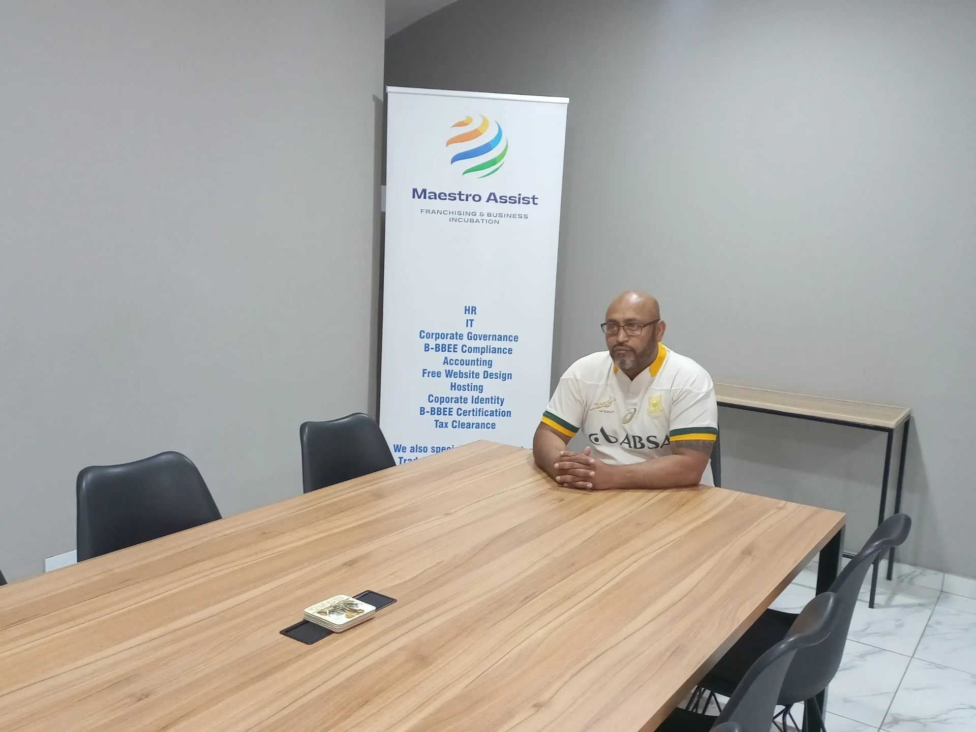 Maestro Assist boardroom with services banner